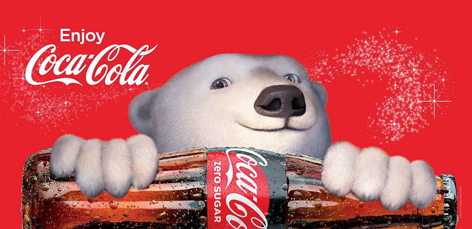 Enjoy Coca-Cola with holiday polar bear holding a large Coca-Cola bottle with sparkles around it for holiday joy.