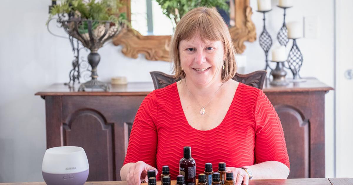 Sitting at a table with essential oils in a display stand