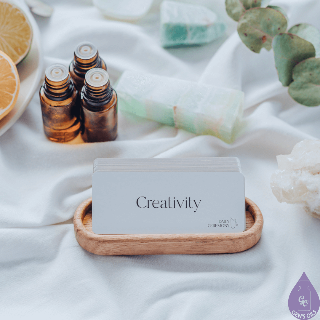 A basket with some Creativity cards, & 3 open essential oil bottles on a tablecloth