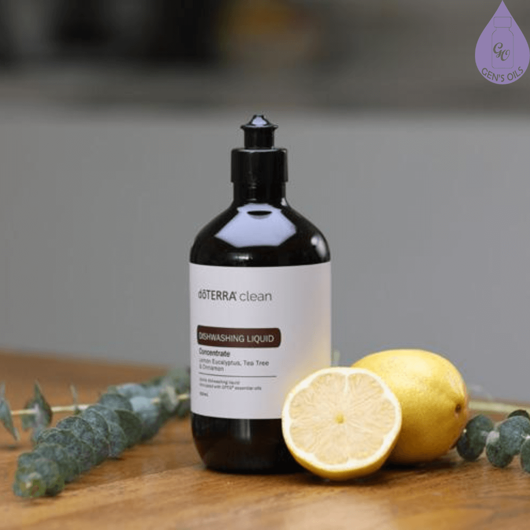 A bottle of doTERRA Clean Dishwashing Liquid with a sprig of Eucalyptus & a lemon on a bench.