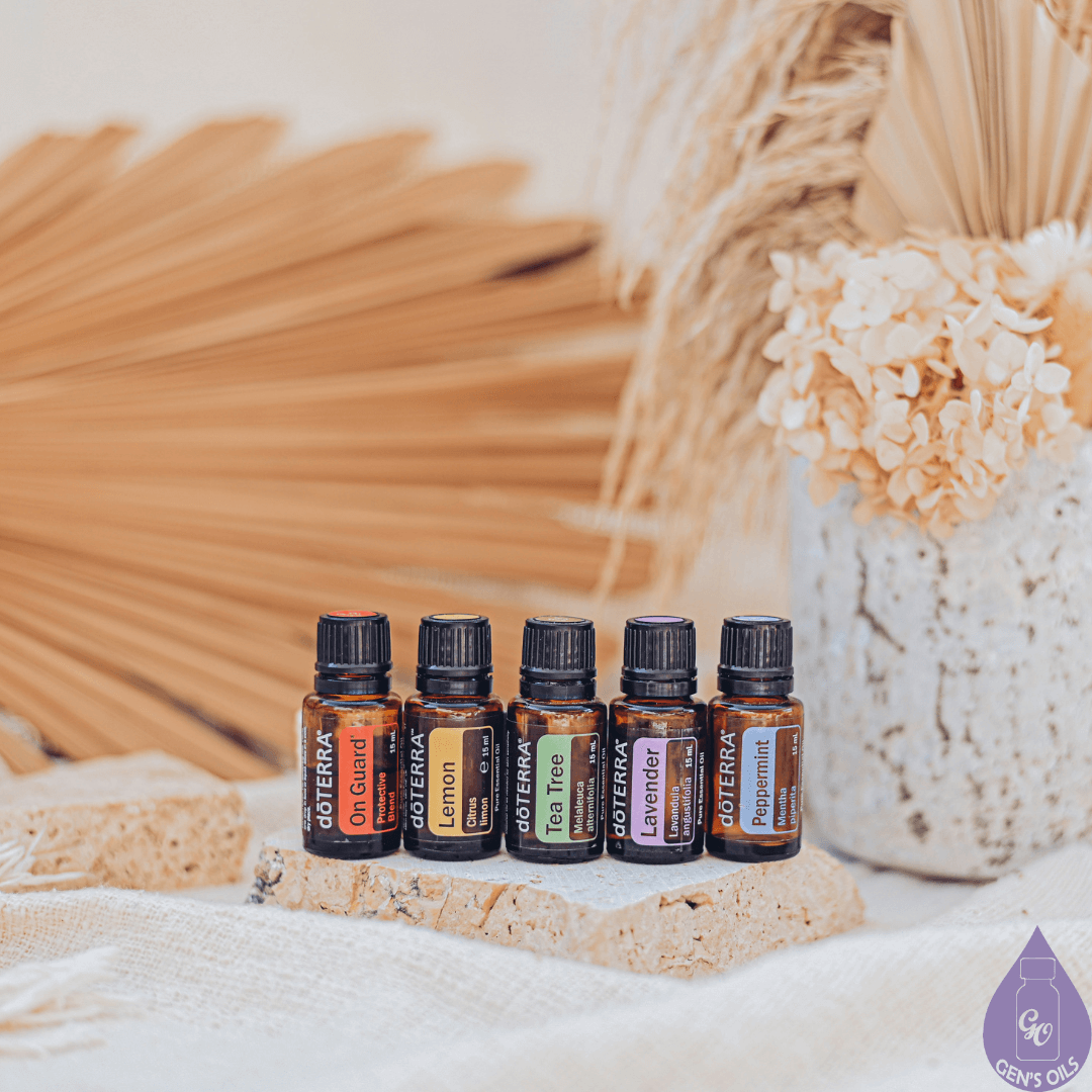 Five bottles of essential oils. On Guard, Lemon, Tea Tree, Lavender, Peace