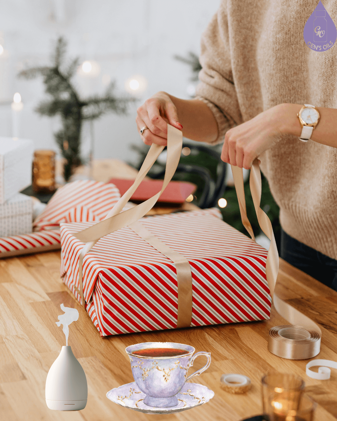 A cup of tea & a diffuser on a table beside a person wrapping Christmas presents.