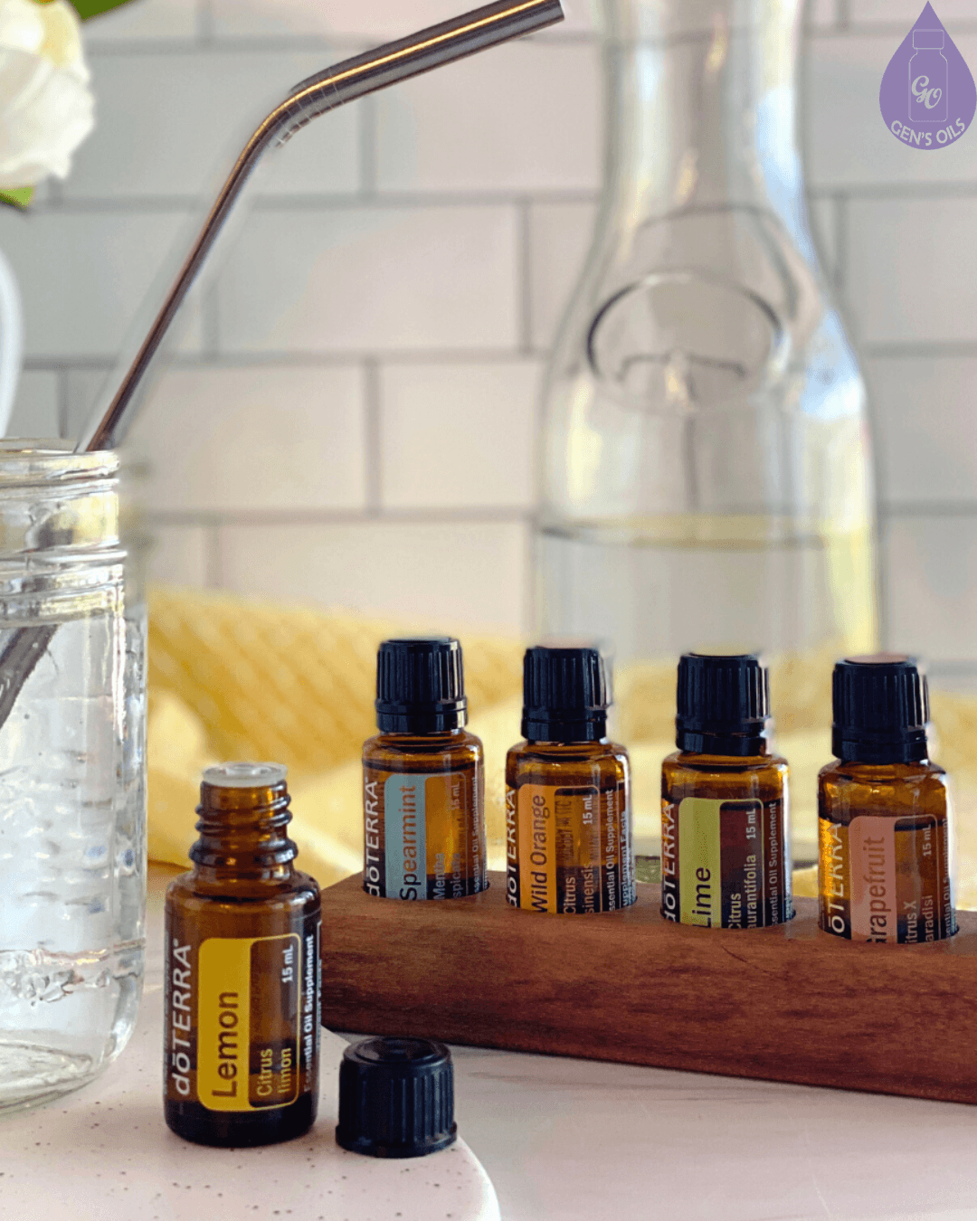 Hydration station, with bottles of doTERRA essential oils, a mason jar of water with a straw & a jug of water.