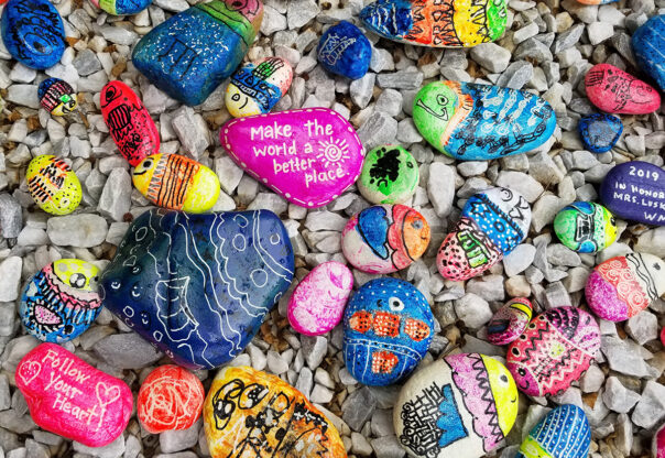 A pile of colourful kindness rocks.