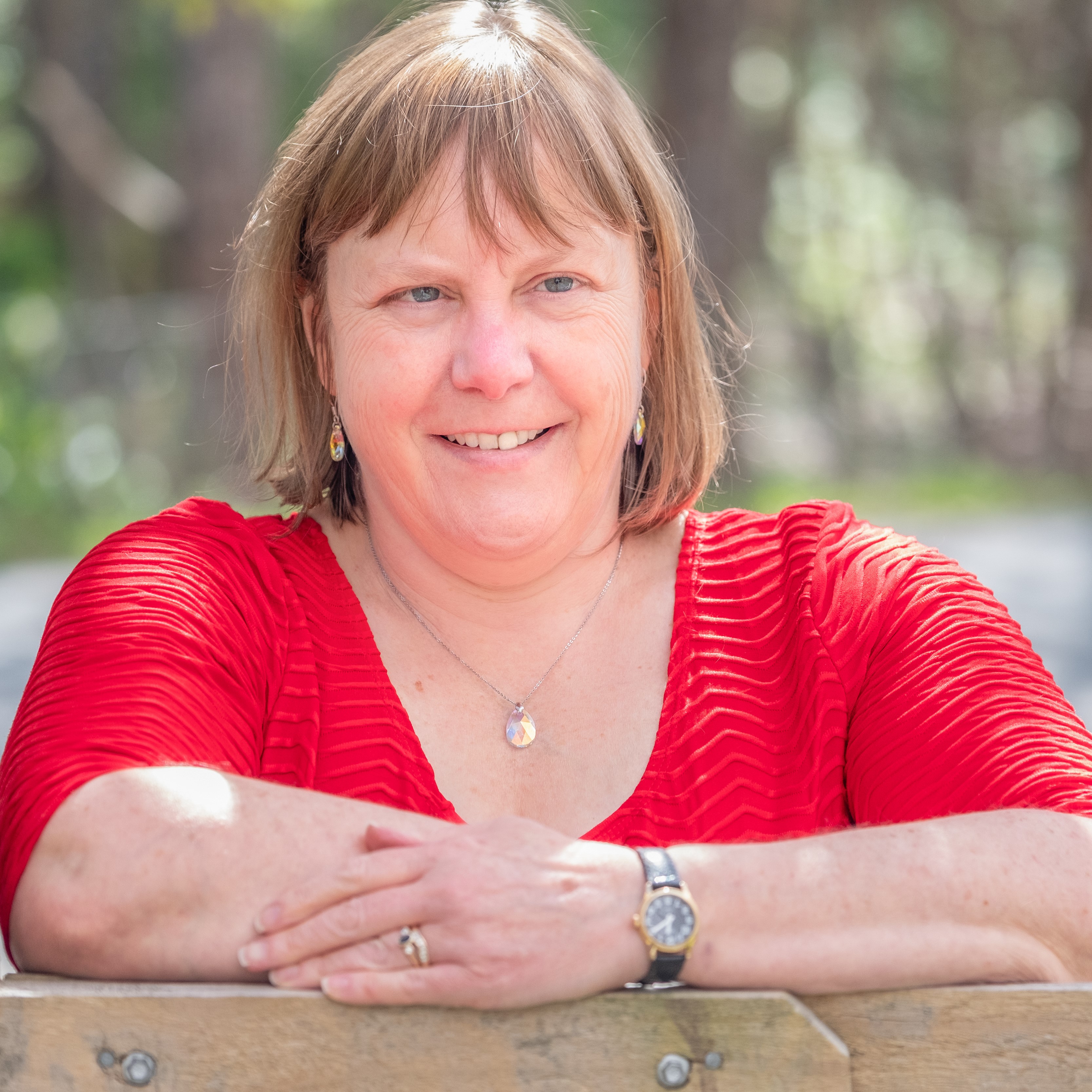 Genevieve leaning on a gate post