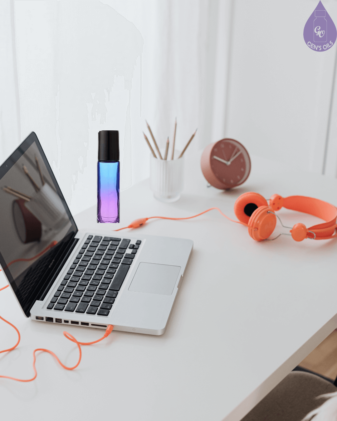 A roller blend on a desk beside a laptop.