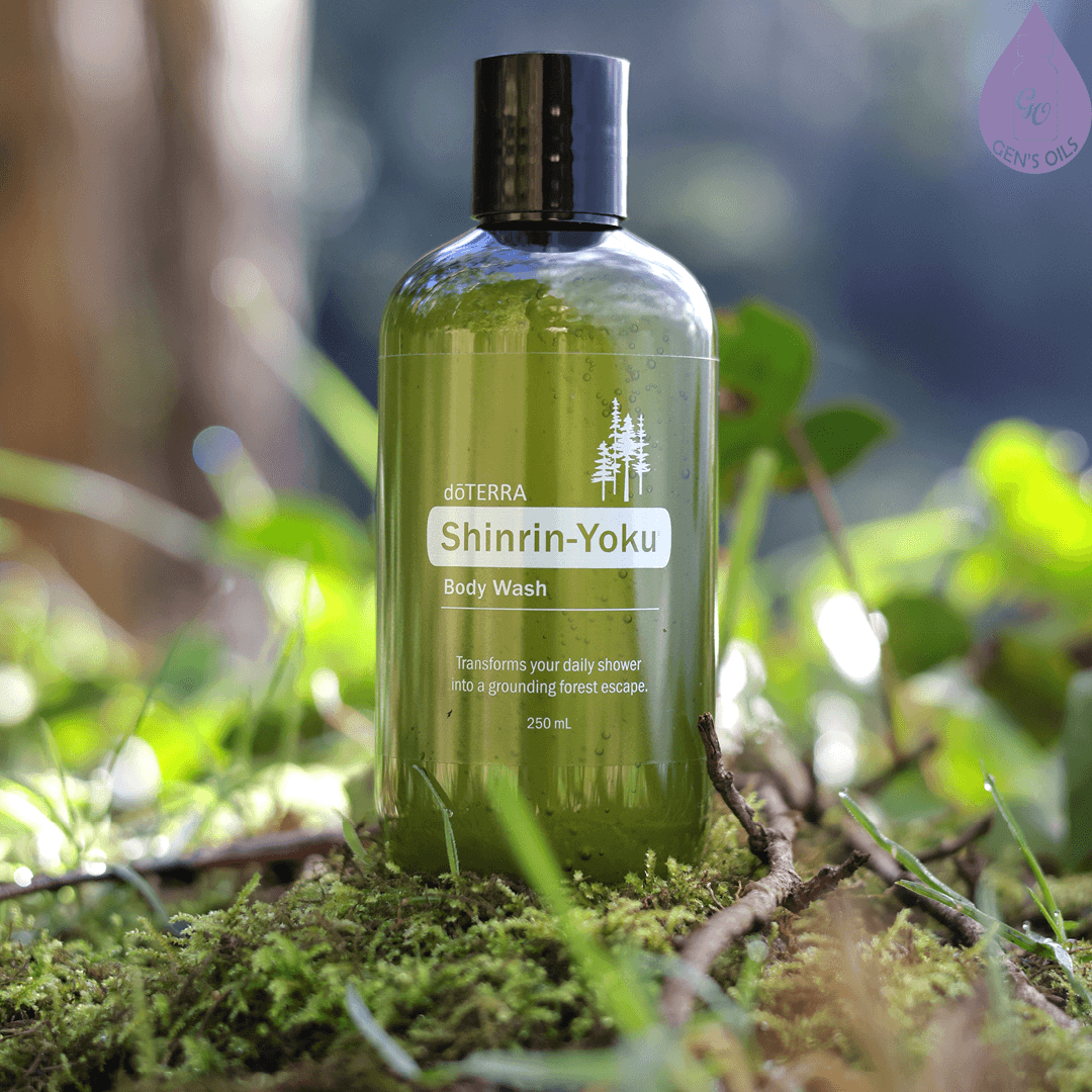 A bottle of Shinrin-Yoku Body Wash sitting on the ground in a forest.
