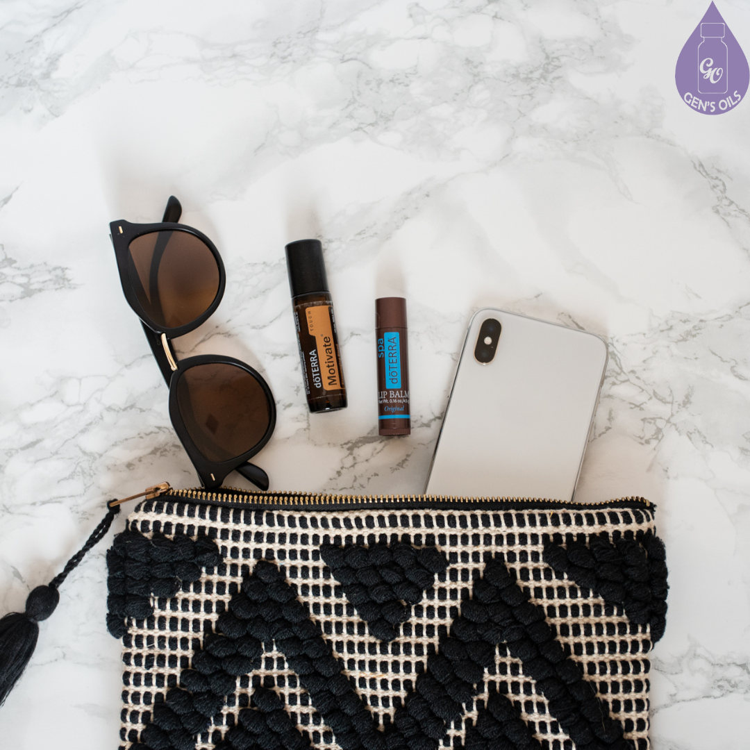 A handbag with a mobile phone, sunglasses & a couple of essential oils.