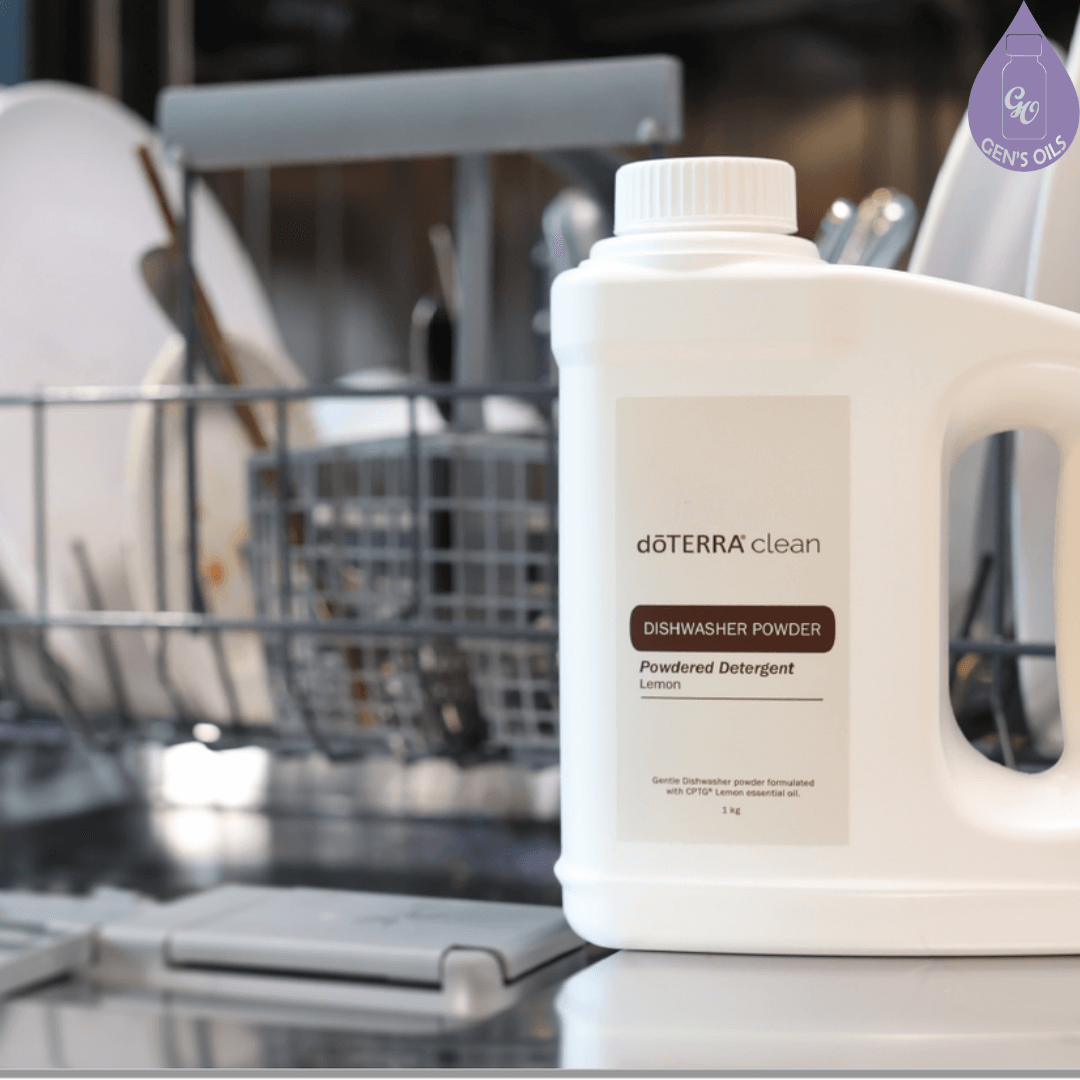 doTERRA Clean Dishwashing Powder on the open door of a dishwasher in front of a rack of dishes.
