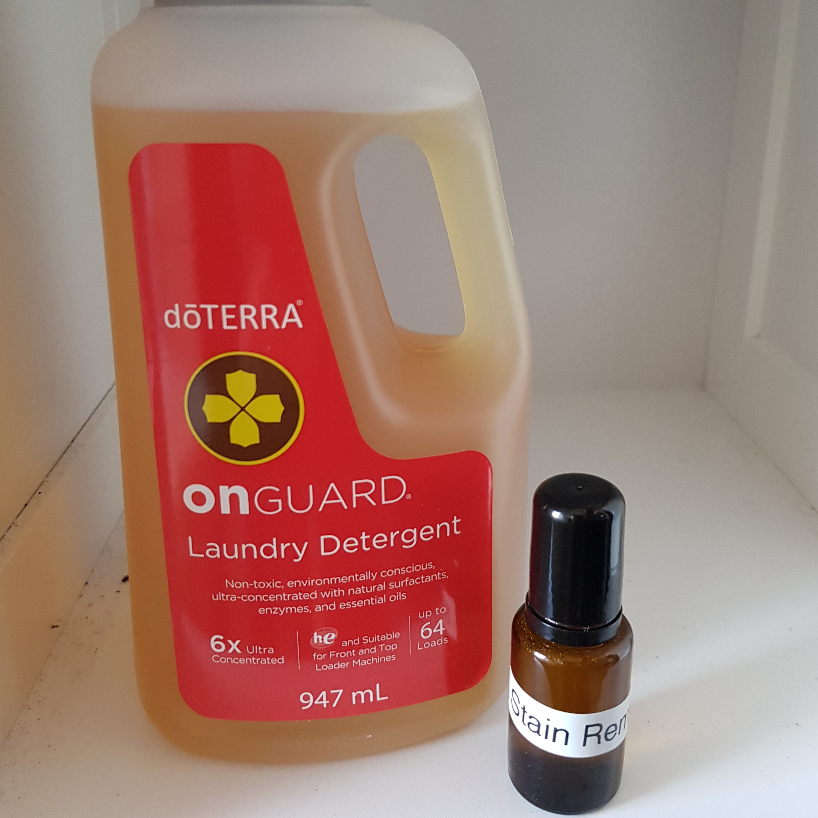 DIY stain remover on shelf beside doTERRA Laundry detergent 