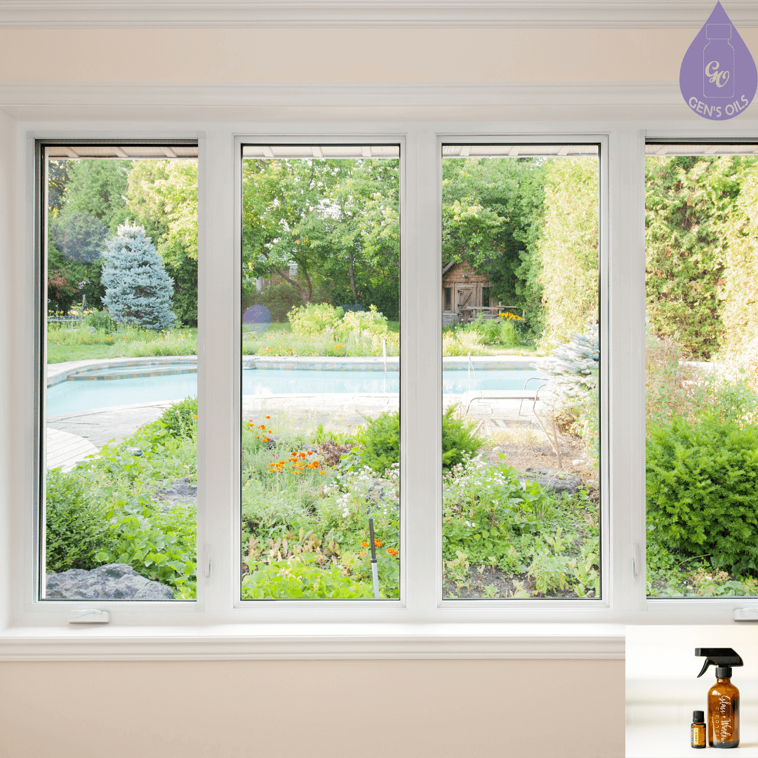 Windows looking out onto a garden & pool, with a bottle of DIY Glass Cleaner in the corner.