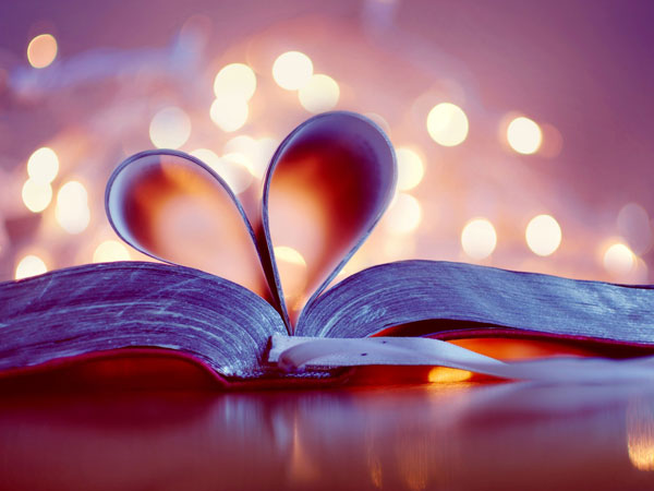 book open with some pages in heart shape