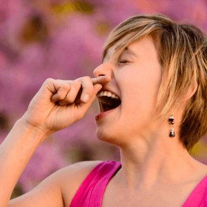Woman outdoors sneezing and experiencing nasal congestion from seasonal hay fever, typical of the allergy symptoms treated with acupuncture at Deanna Thomas clinic in Middlesbrough
