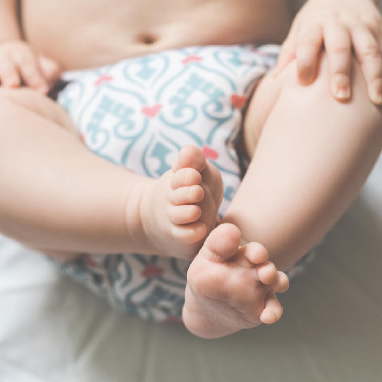the lower body of a baby wearing a diaper