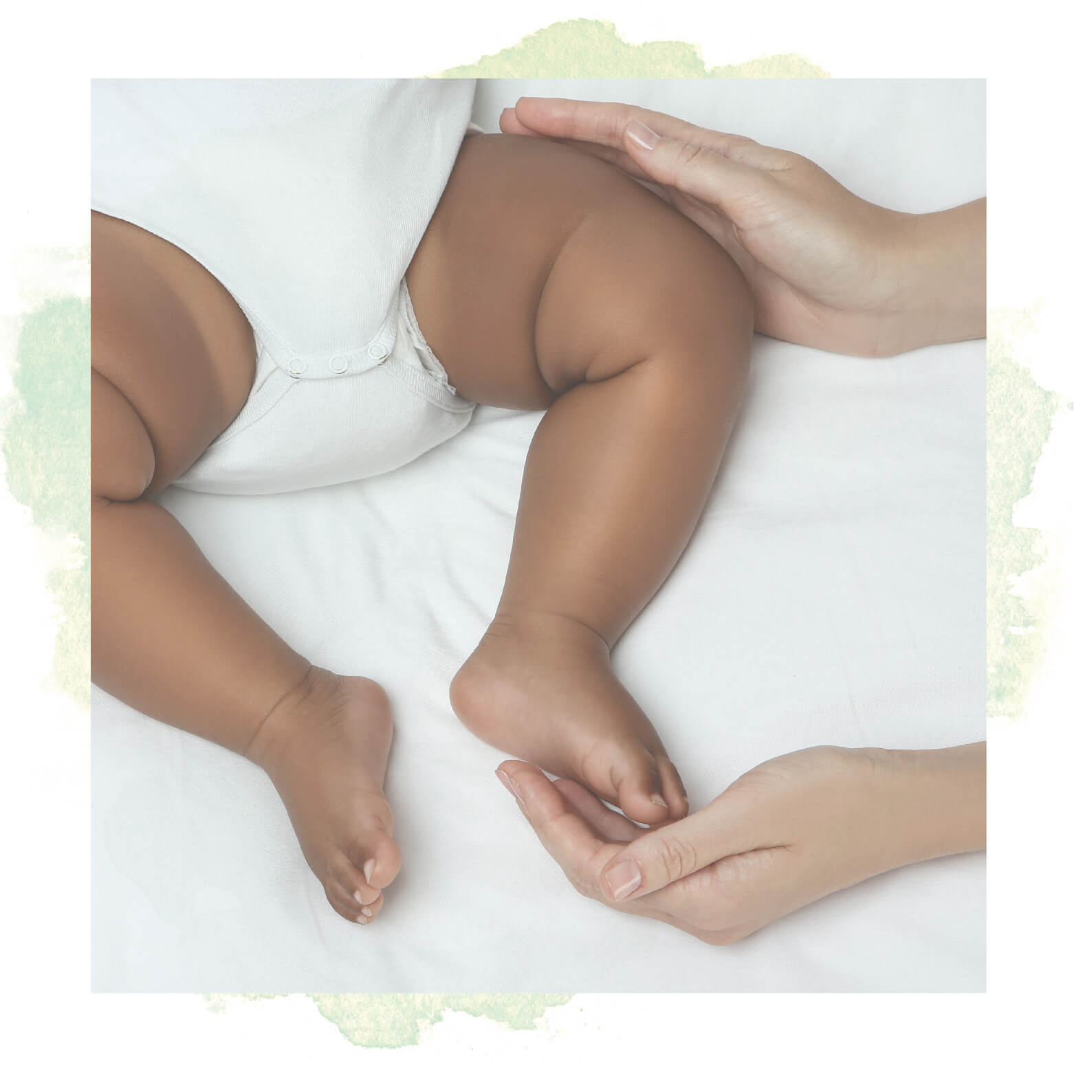 woman touching the feet of a baby in a diaper