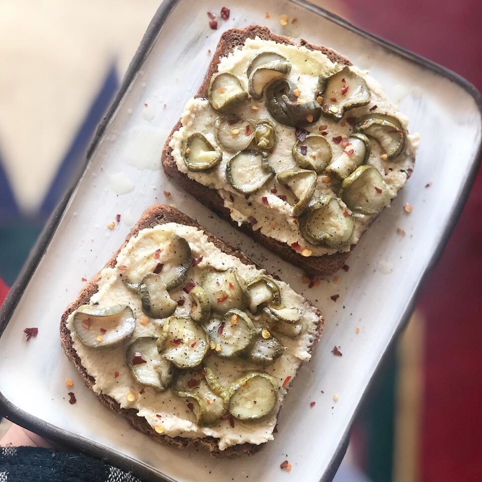 Cashew Chèvre on toast, topped with zucchine in olio d’oliva (zucchini in olive oil), black pepper, and chili flakes