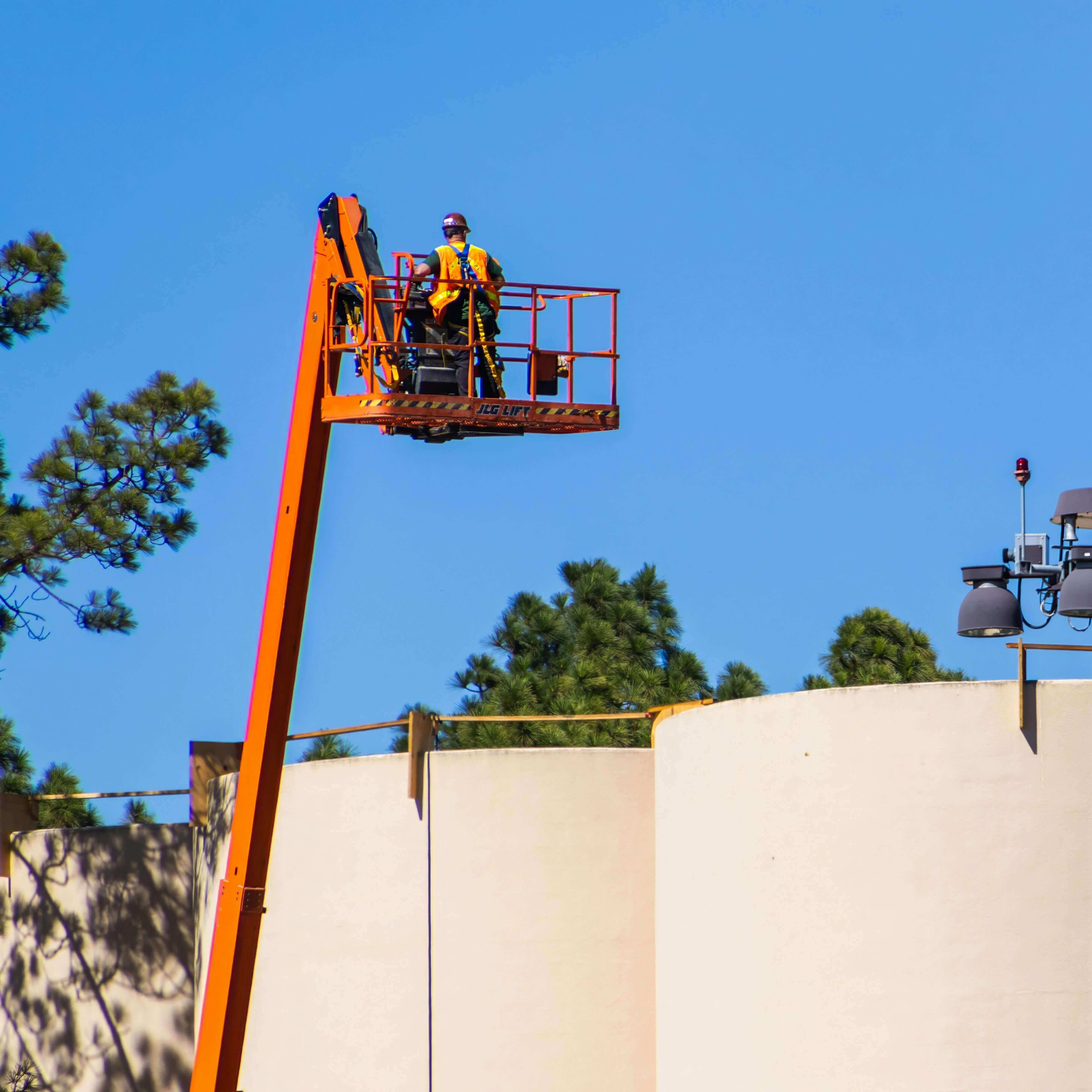 Guy in a manlift over a structure