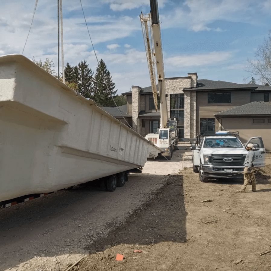 Crane lifting a pool in order to set the pool in position.