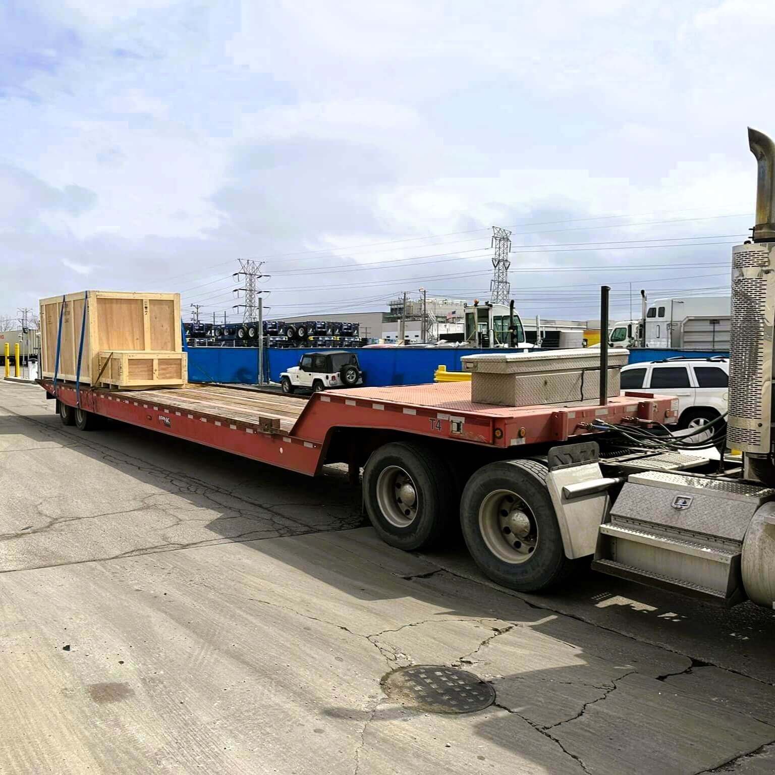 A semi-truck hauling a load of units.