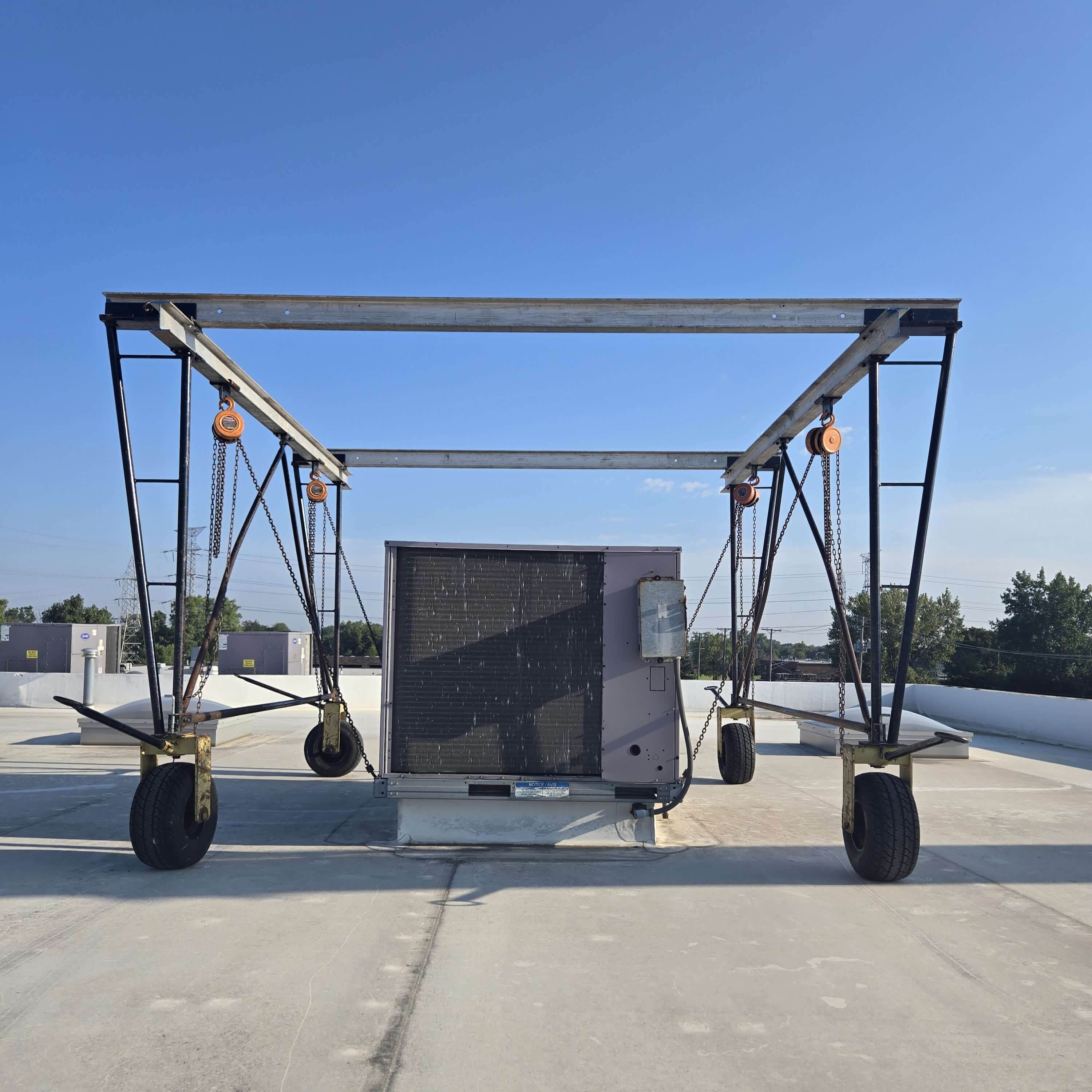 Gantry Crane on the top of a building helping move a heavy load.