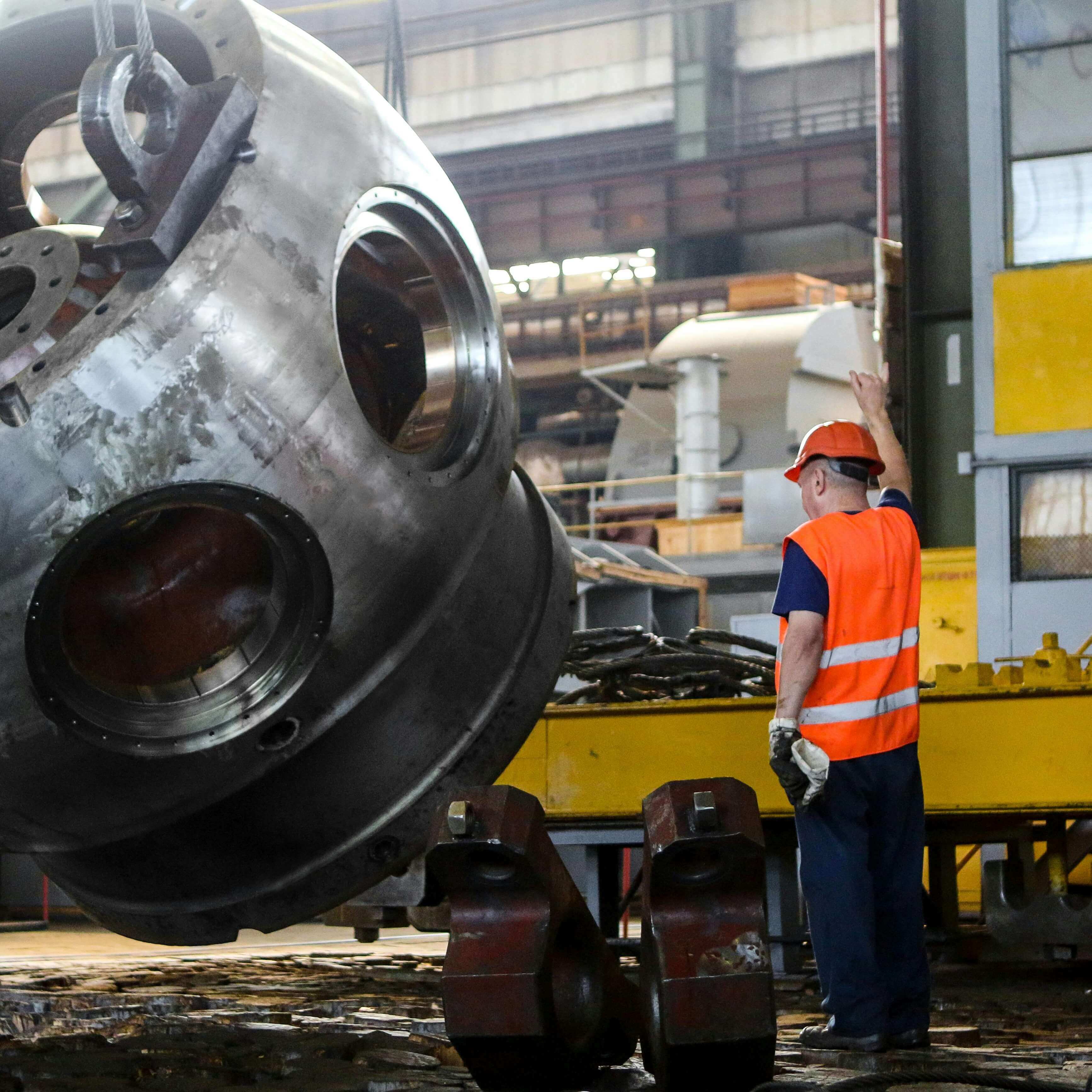 Laborer in safety gear lifting a unit. 