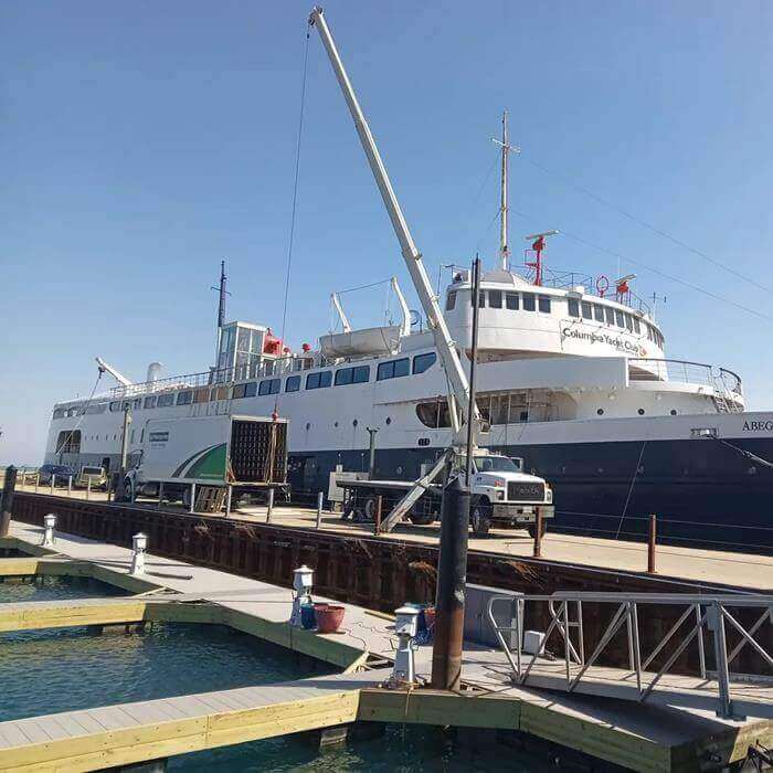 Crane lifting a unit into a cruise ship.